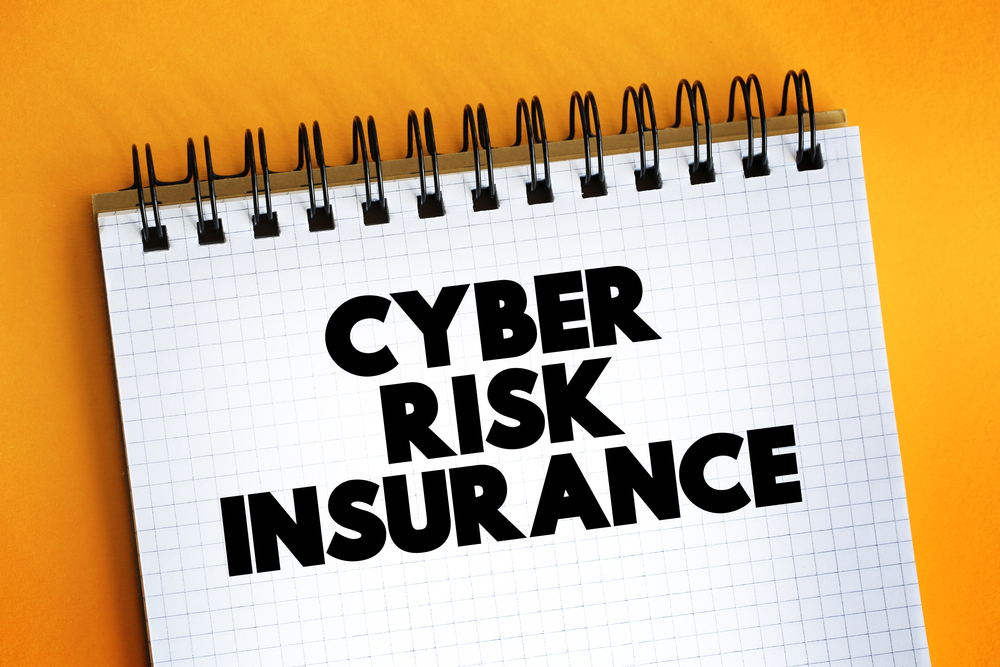 Cyber Risk Insurance text quote on notepad