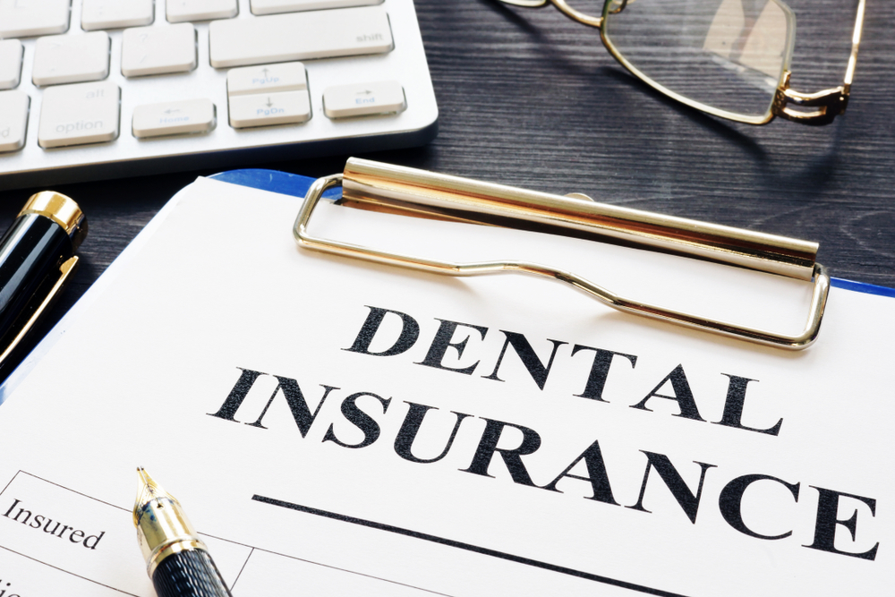 Dental insurance form and pen on a desk.
