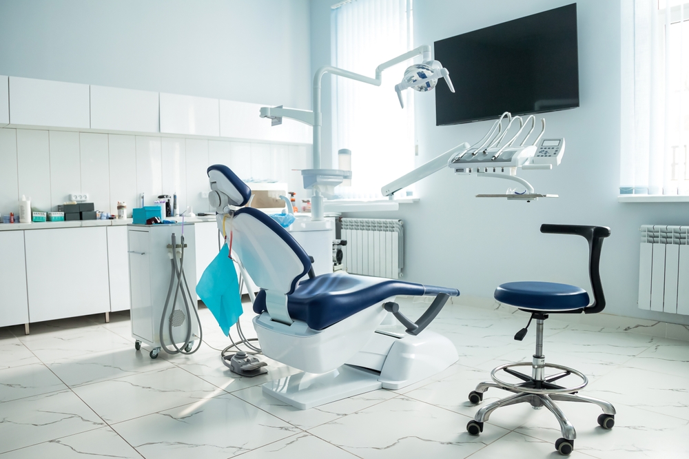 Dental equipment in dentist office in new modern stomatological clinic room. Background of dental chair and accessories used by dentists in blue, medic light.